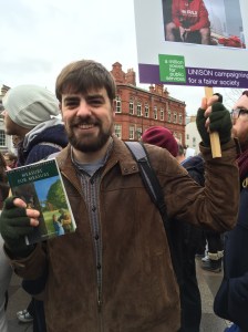 Book in one hand, placard in the other!
